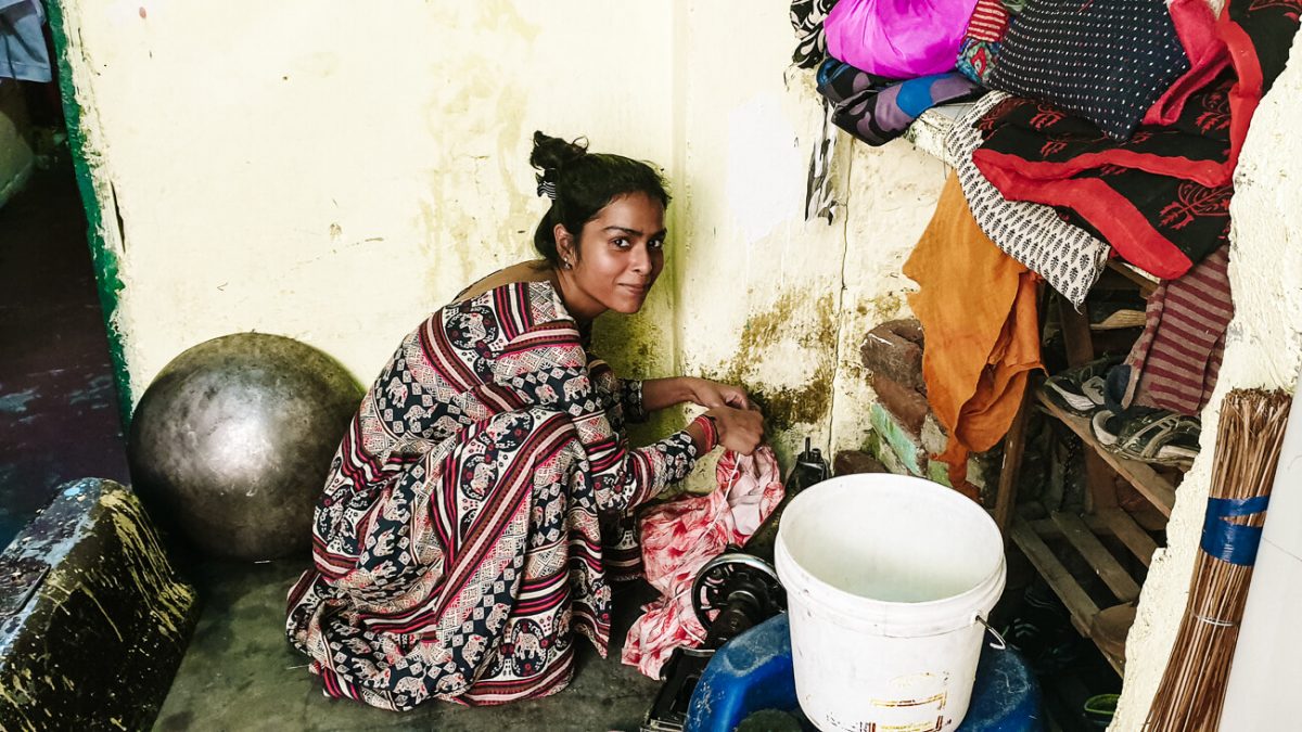 Indian women doing laundry in her home