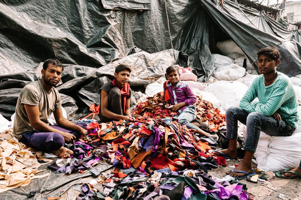 indian men working in recycling of clothes