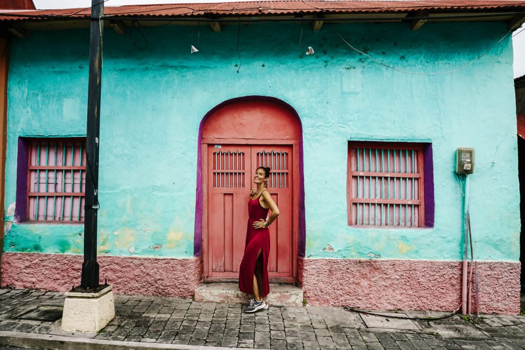 woman in front of colorful houses in Flores Guatemala