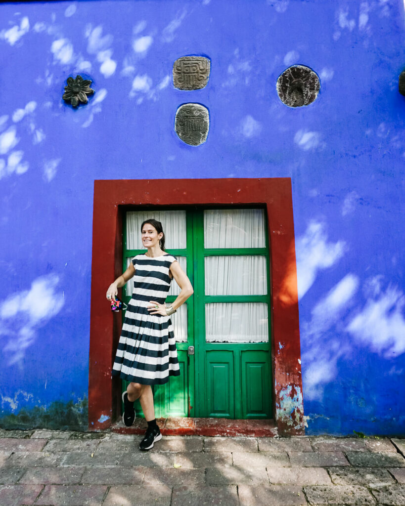 Deborah in front of blue walls in Mexico City.