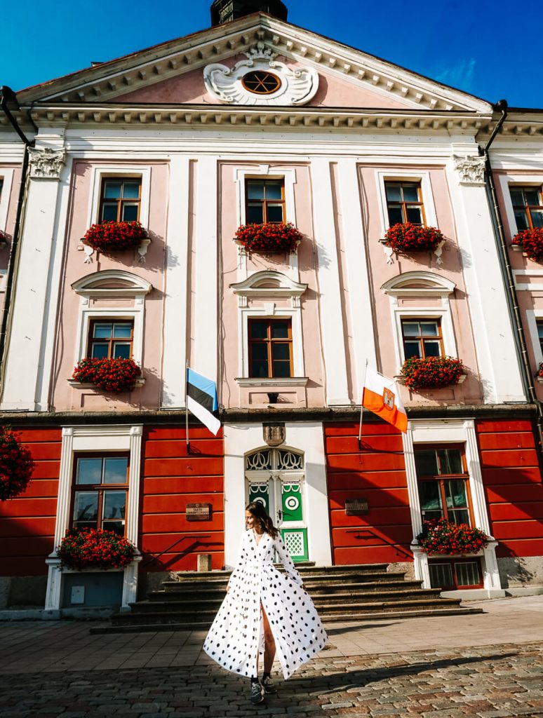 Deborah in front of town hall at Raekoja plats, one of the famous things to do in Tartu Estland