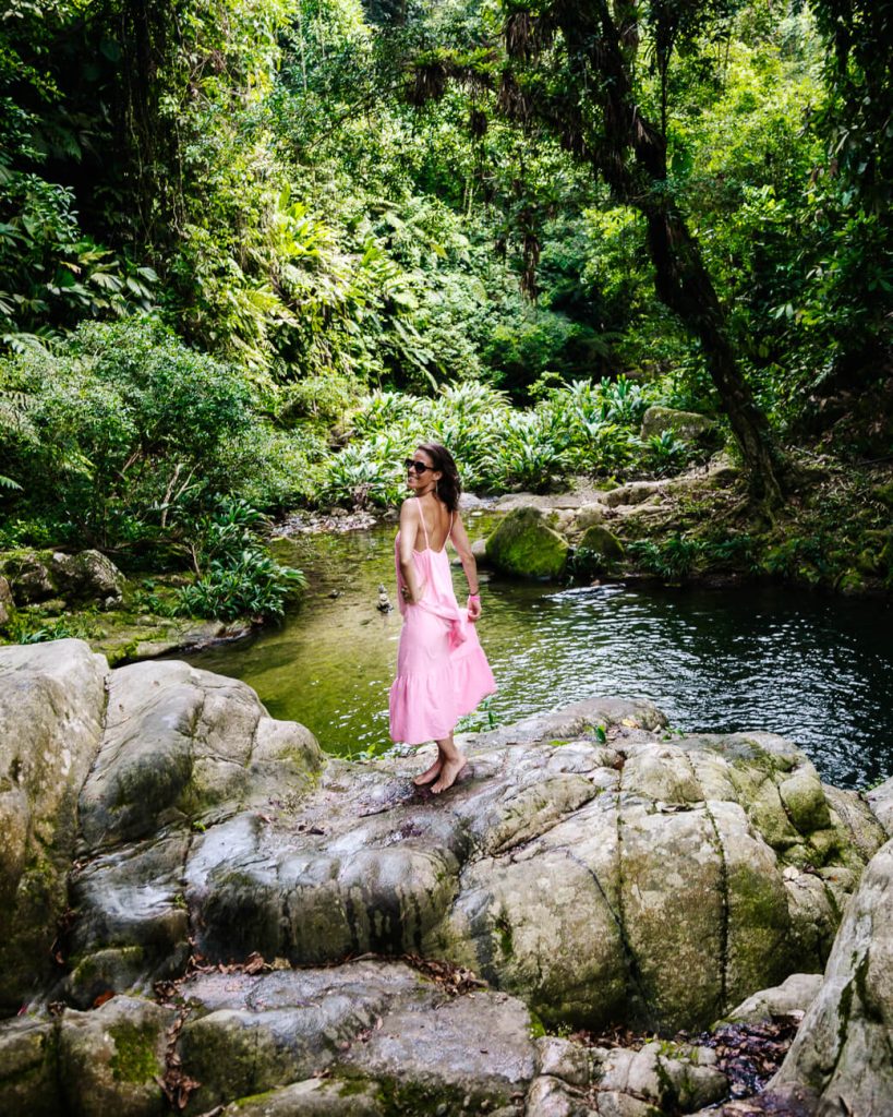 Deborah posing at river and waterfall in Colombia