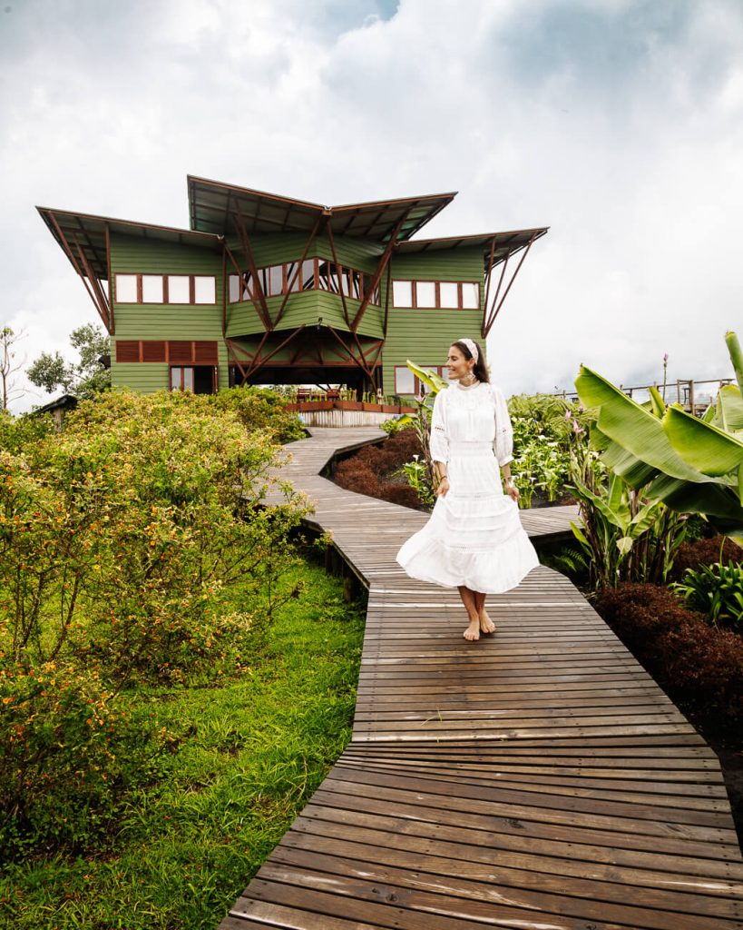 Deborah on trail in front of restaurant in el nido del condor hotel in Colombia