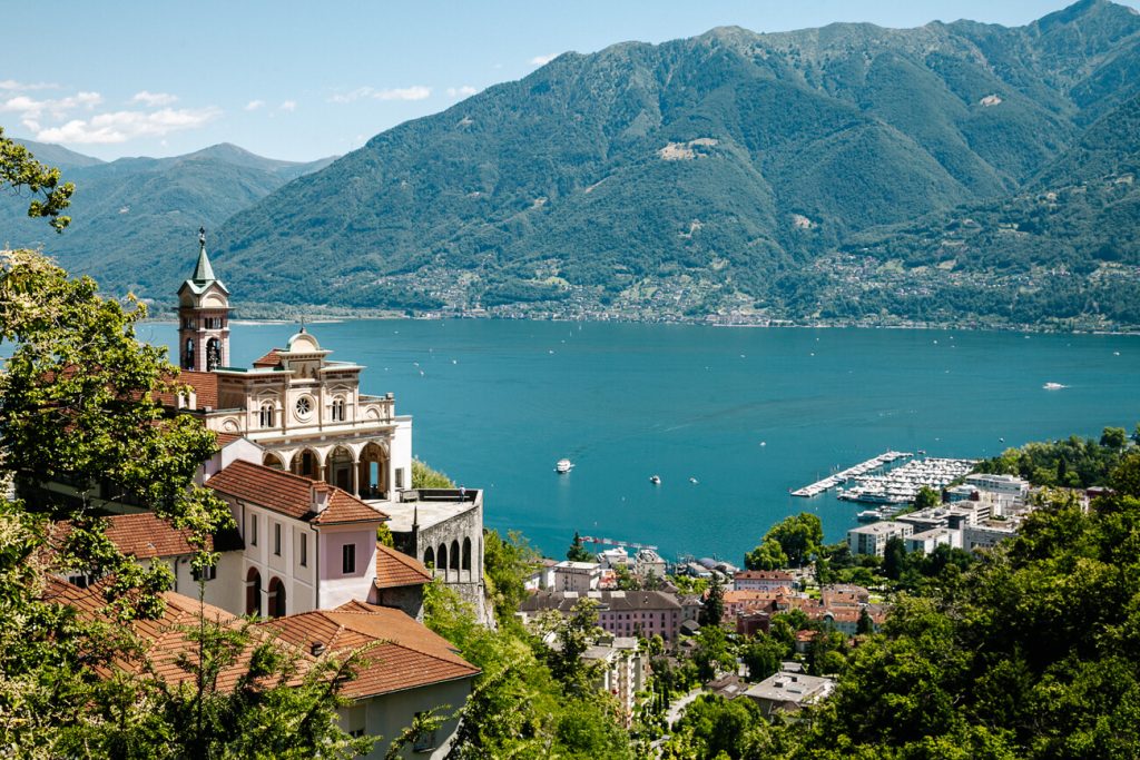 High above the glittering Lake Maggiore, halfway up the mountain, you’ll find the Santo Monte Madonna del Sasso Monastery, located in the municipality of Orsolina. One of the best things to do in Ticino Switzerland 