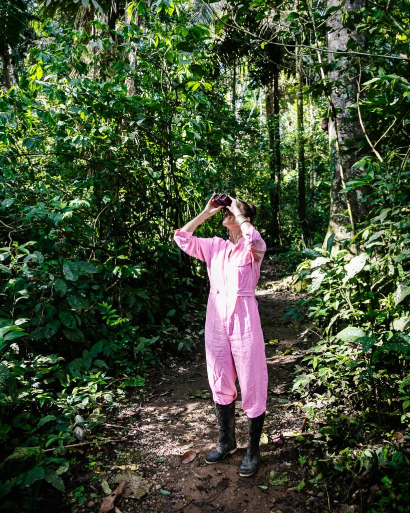 Deborah with binocular around Tambopata Research Center jungle lodge, by Rainforest Expeditions Peru.
