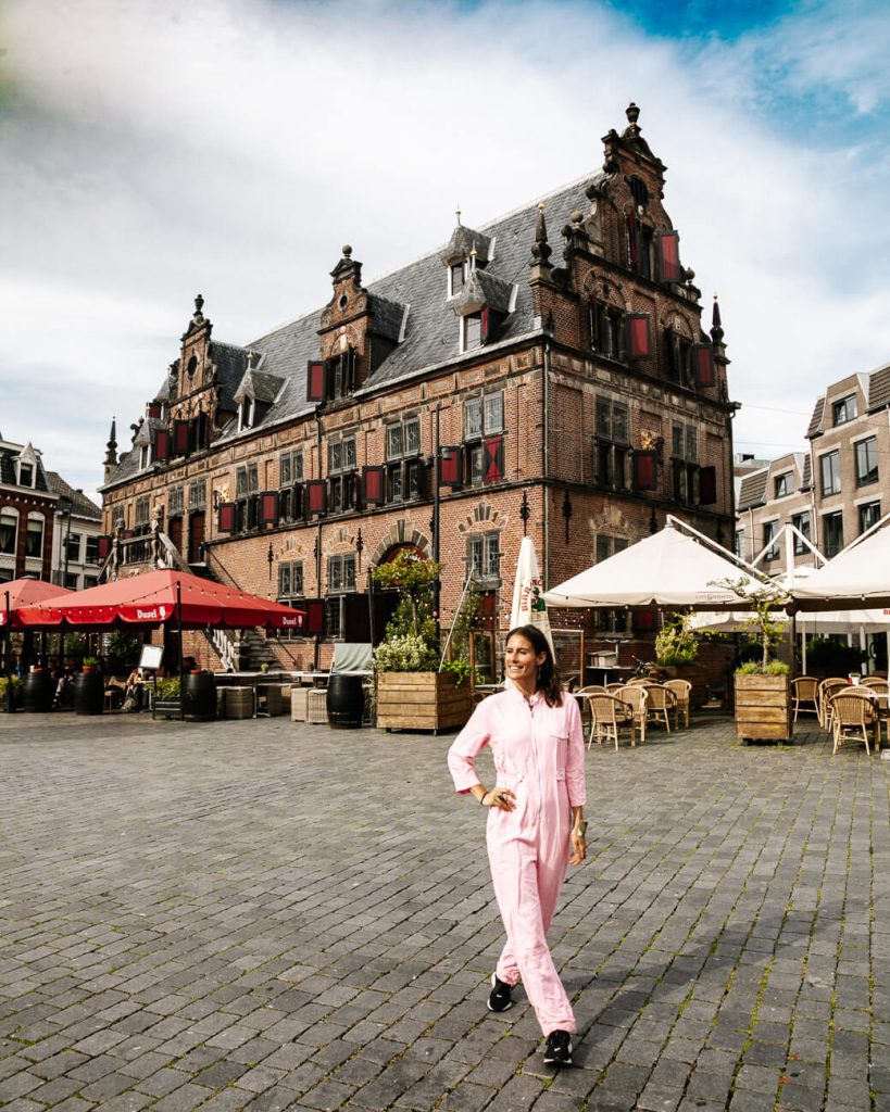 Deborah in front of the Boterwaag at the Grote Markt, one of the best places to visit and things to do in Nijmegen