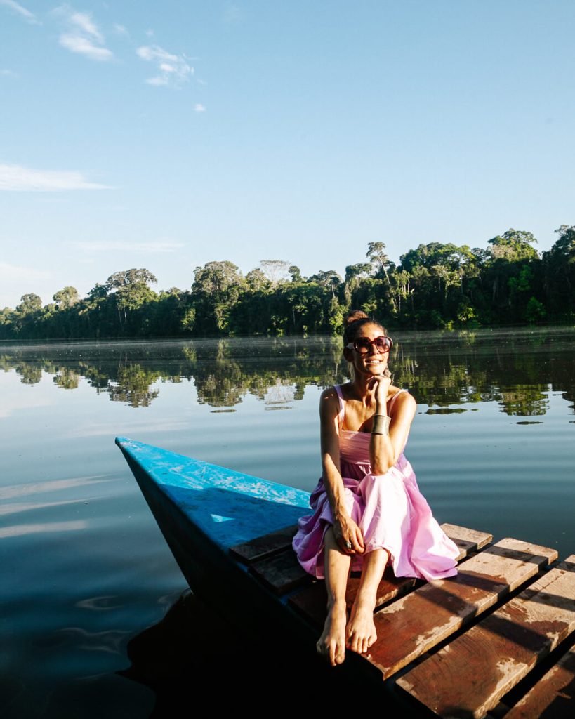 Deborah on wooden catamaran in Oxbow lake in Tambopata Peru.