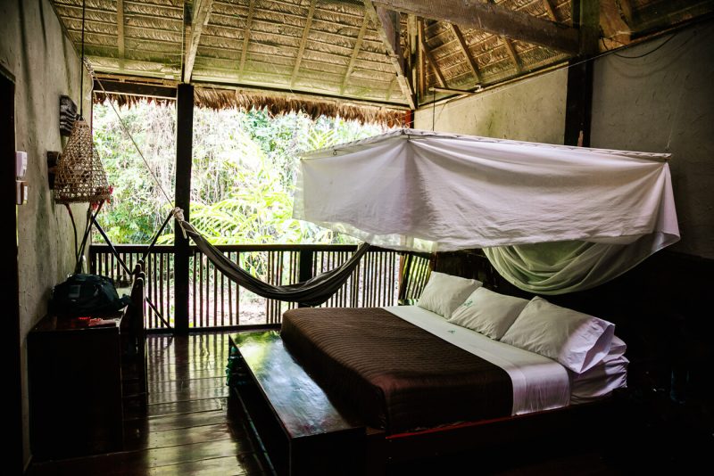 Deluxe room with open side to the jungle and large beds at Posada Amazonas - jungle lodge Tambopata Peru, by Rainforest Expeditions.