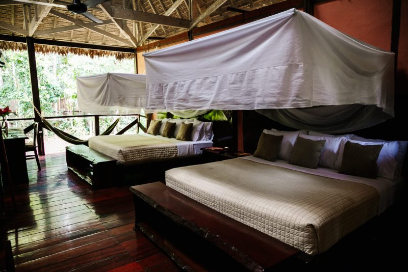 Deluxe room with open side to the jungle and large beds at Refugio Amazonas - jungle lodge Tambopata Peru, by Rainforest Expeditions.