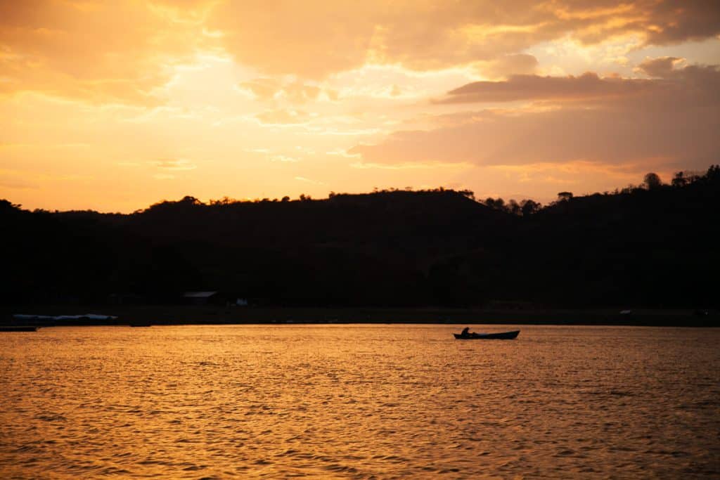 Sunset from boat at Suchitlán lake, one of the best things to do in Suchitoto in El Salvador.