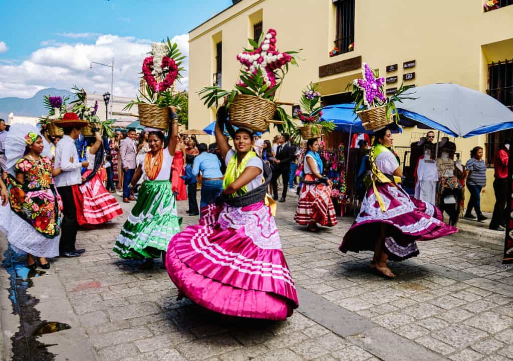 The Guelaquetza festival is an indigenous cultural festival with traditional costumes and dancing, native food and artisanal crafts in Oaxaca Mexico.