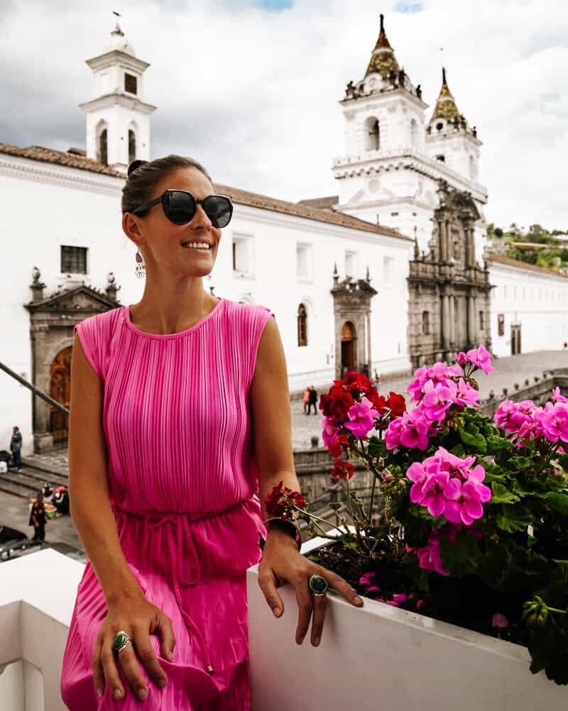 Deborah on balcony of Casa Gangotena with view of Plaza San Francisco in Quito.