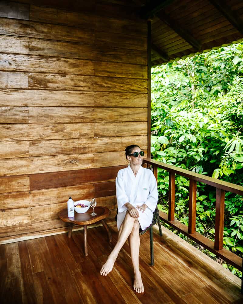 Deborah sitting on balcony of room in Sacha Lodge in Ecuador.