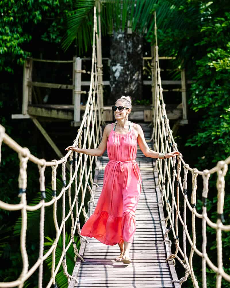 Deborah on suspension bridge in rainforest in Belize.