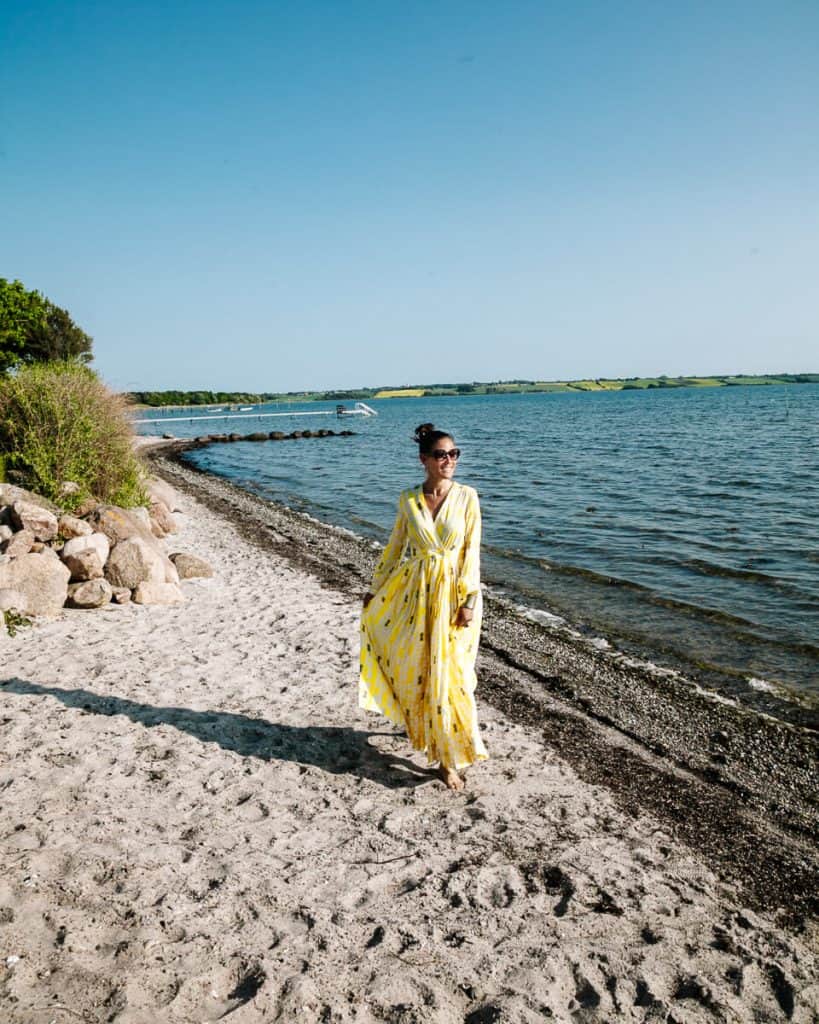 Deborah on the beach - discover the best things to do in Fyn in Denmark, with tips for hikes, cultural activities, food and unique places to stay.