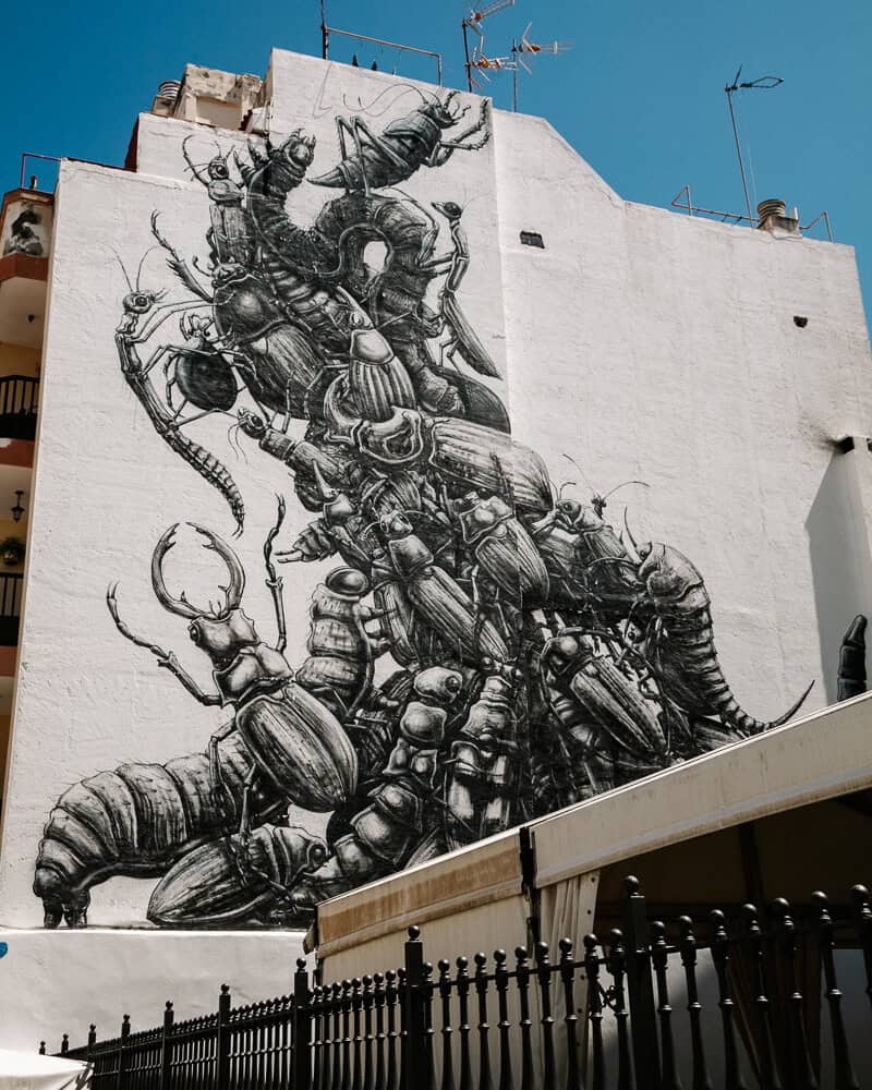 In the streets of the Barrio La Ranilla district in Puerto de la Cruz, there are narrow streets with many restaurants and street art works on the walls.